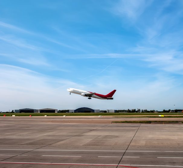 The plane was about to take off on the runway on the background of blue sky with Cirrus clouds