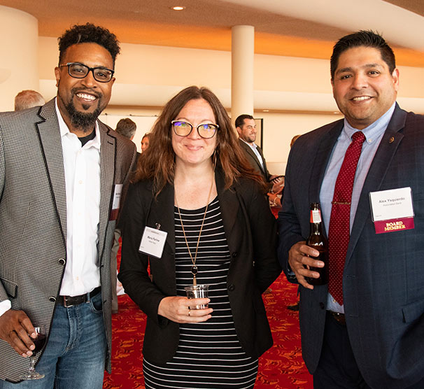 three business people at an event