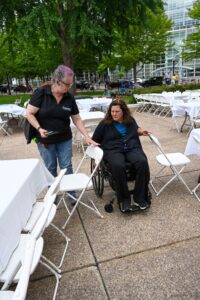 Accessibility services image of people evaluating event chair spacing